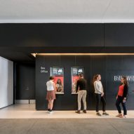 Theatre box office with black walls and wooden floors at the Hammer Museum