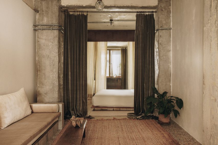 Guest room with exposed concrete walls in hotel by House of Shila