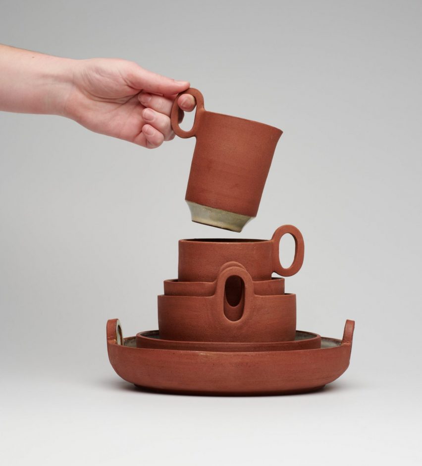 Terracotta plates dishes and mugs stacked together by a New Designers winner