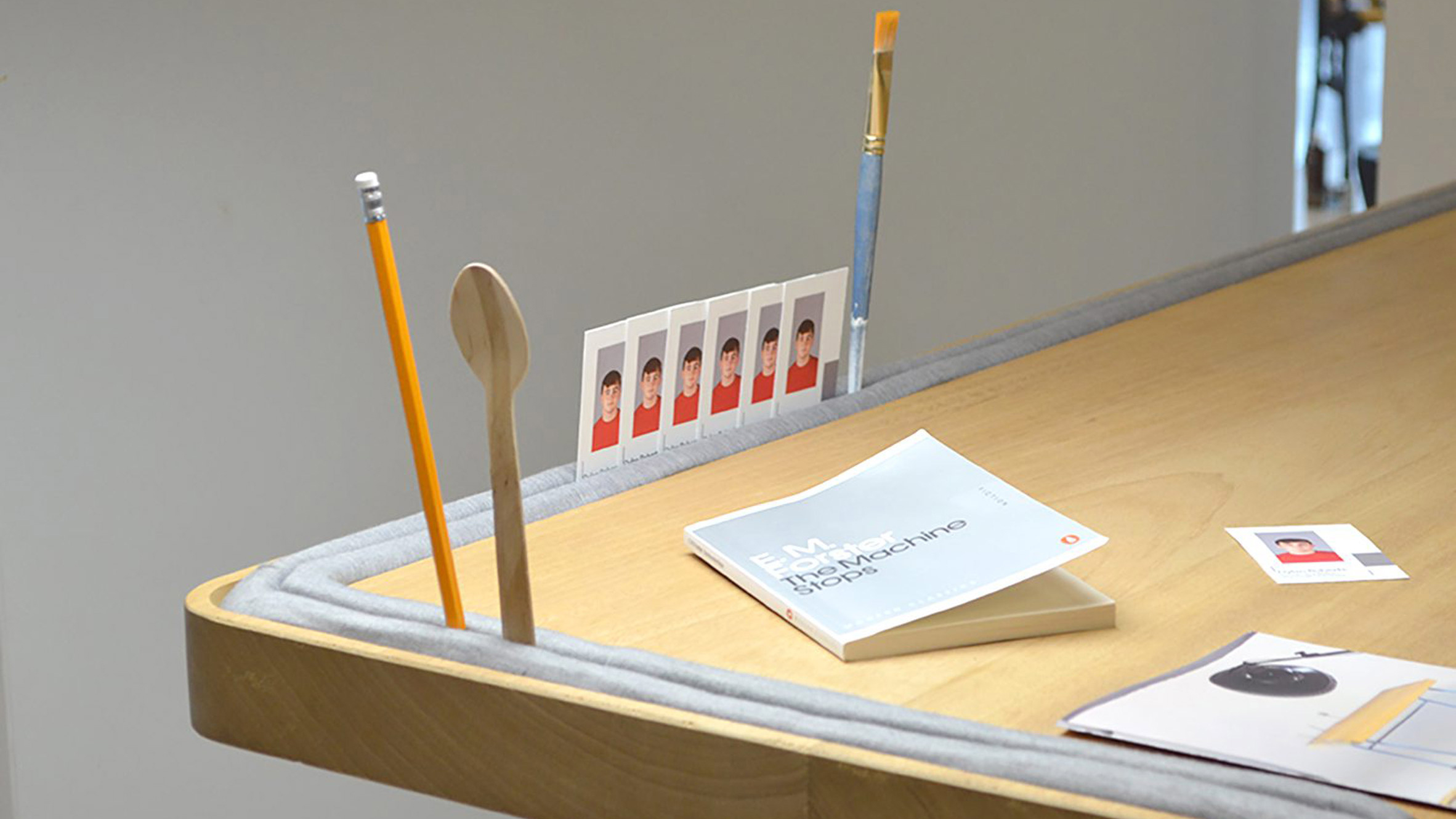 Photograph showing desk with lip around edge to hold things