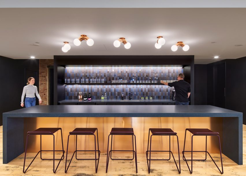 Dark blue bar with large counter and five stools