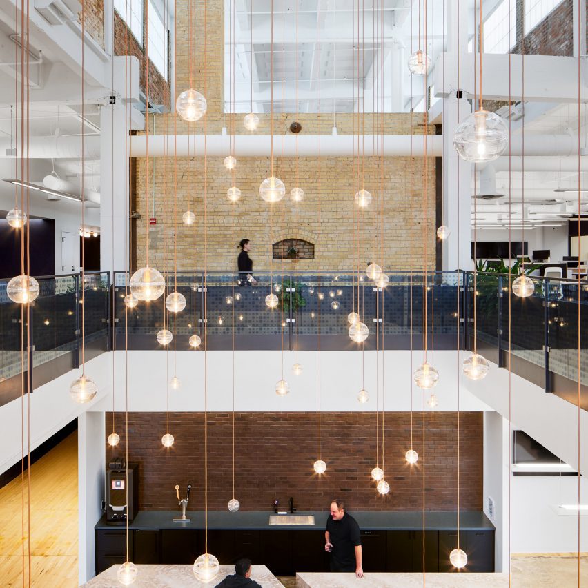 Atrium filled with glass globe lights suspended on individual wires