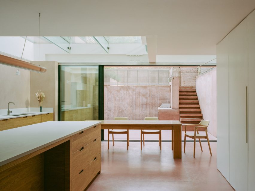 Wooden kitchen with pink-concrete floor