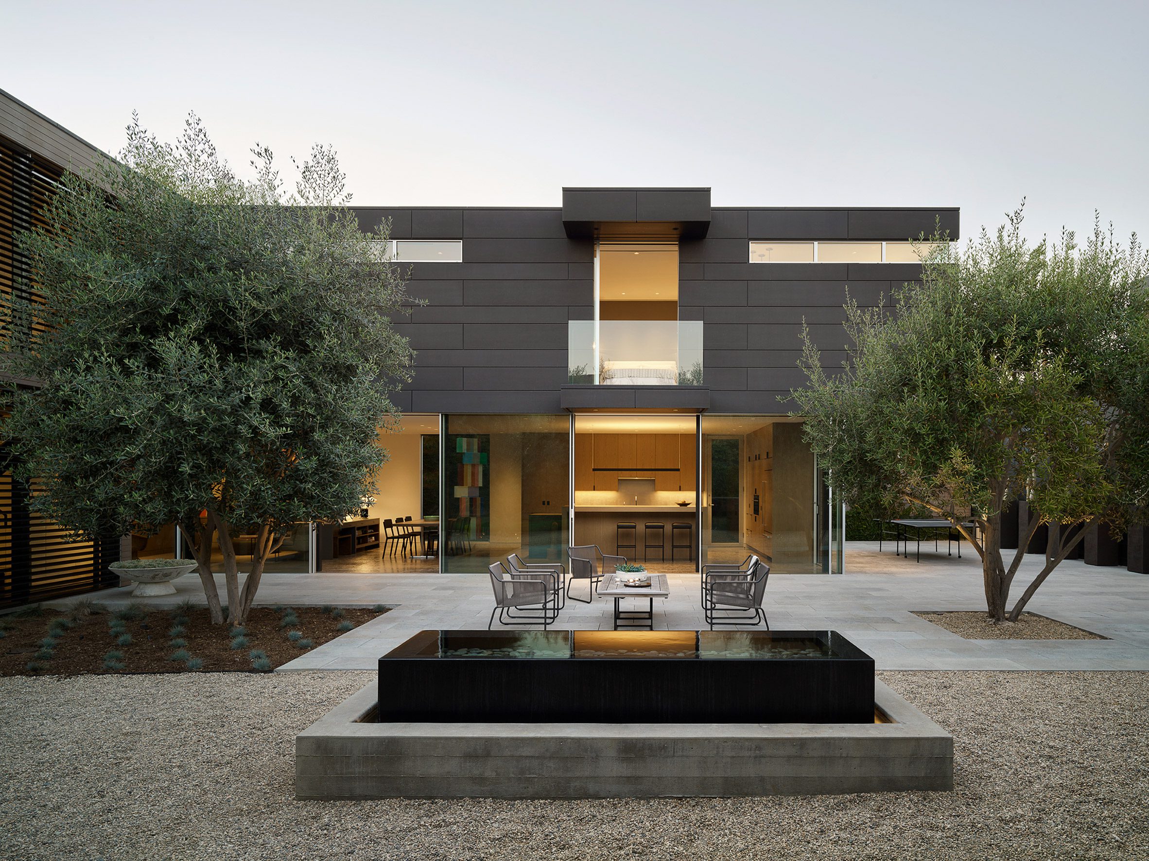 A black clad house with seating outside