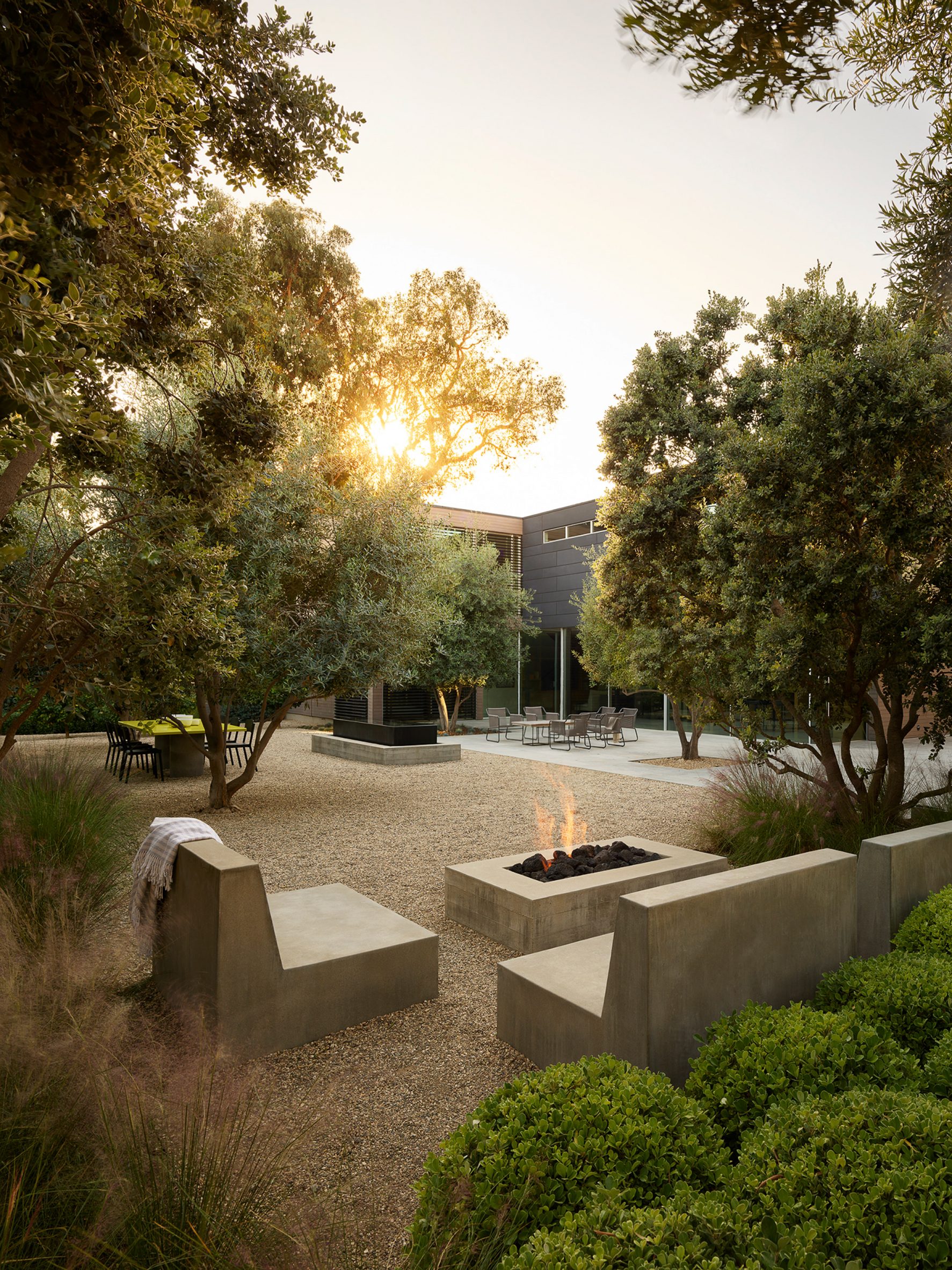 Courtyard with a custom fire pit by Walker Warner Architects