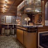 Bar interior with wood-panelled walls and mosaic flooring
