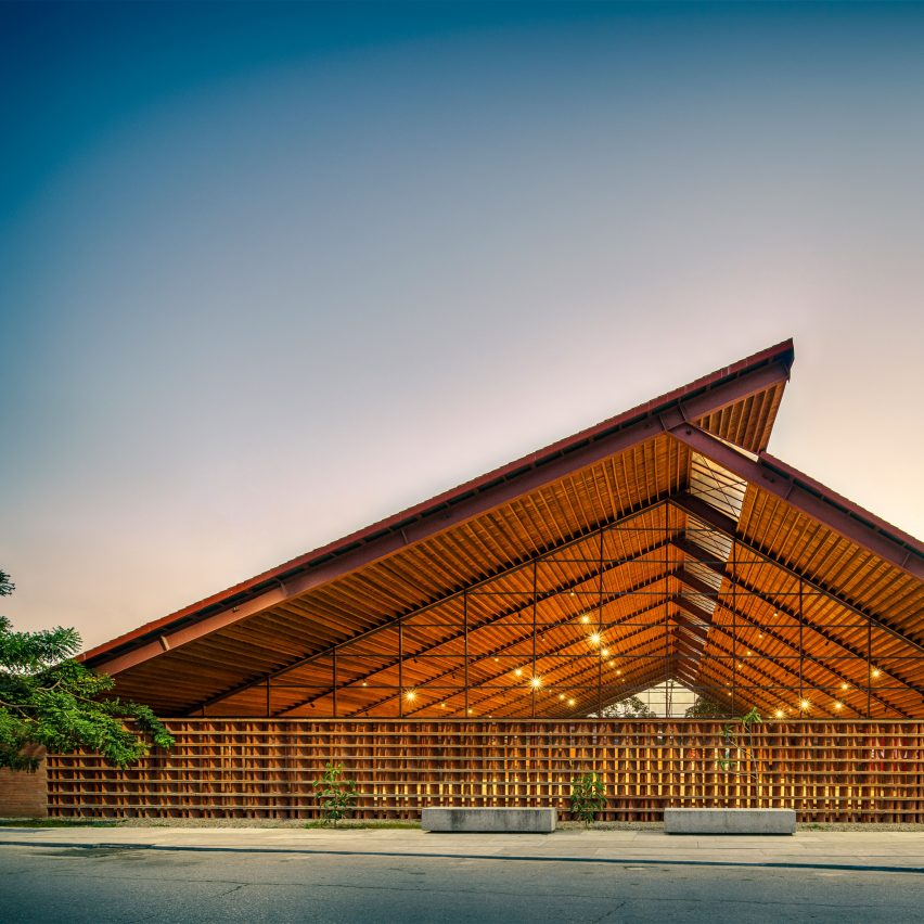 Exterior of the brick Casa de Musica school by Colectivo C733 with a cantilevered timber roof