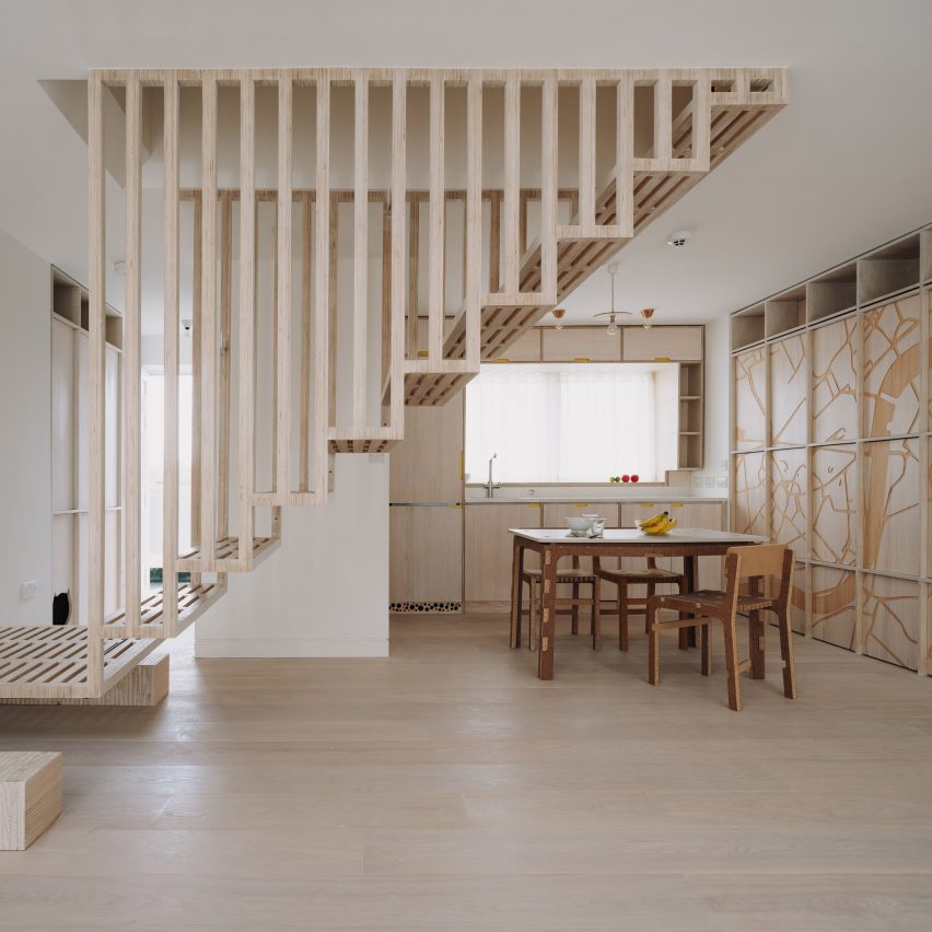 Staircase and kitchen in Dragon Flat by Tsuruta Architects