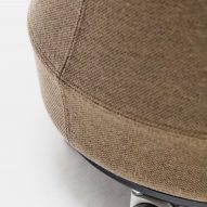 Close up of a brown fabric-upholstered Stump stool by Derlot