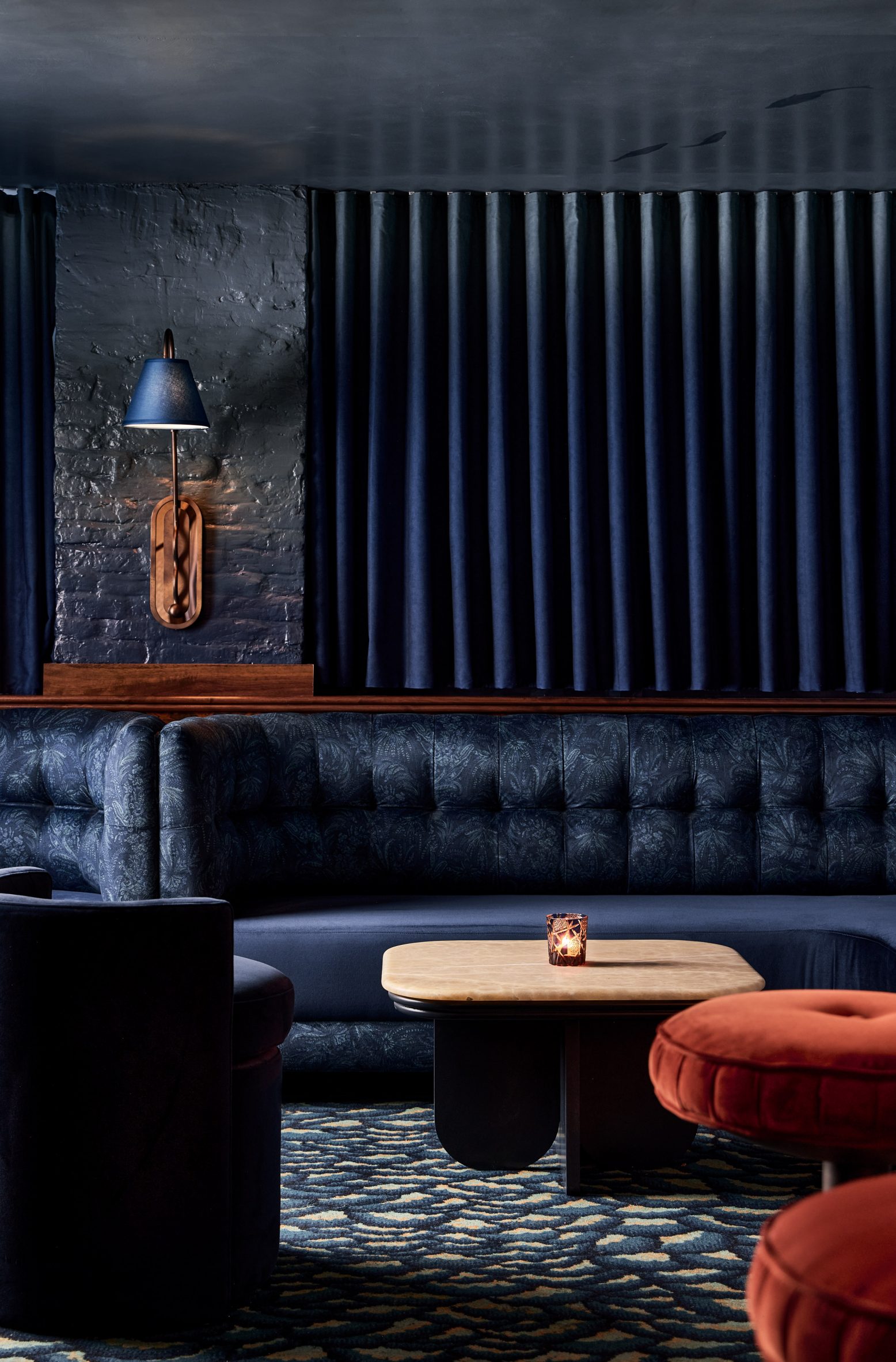 Dark blue lounge with plush banquettes