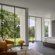 Bedroom with floor-to-ceiling windows, a double bed and a yellow lounge chair