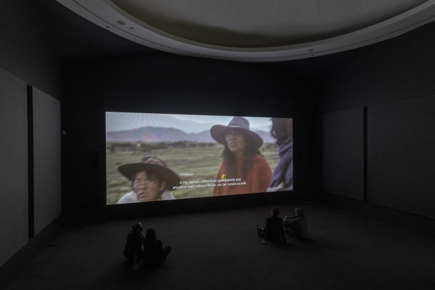 Photo of a video artwork playing inside a darkened gallery