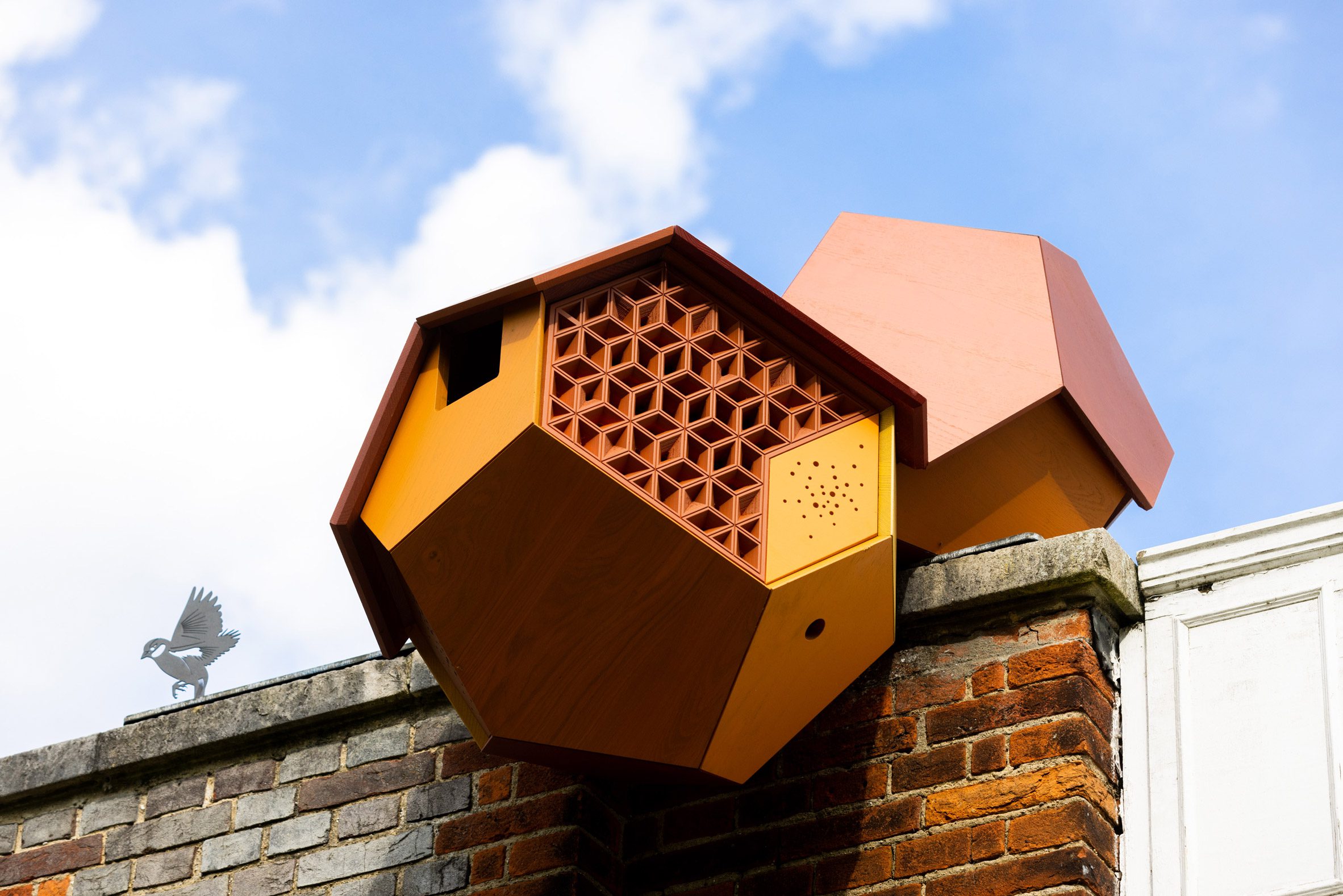 Close-up photo of a smaller Cloud Cities sculpture perched on the facade of the Serpentine South gallery
