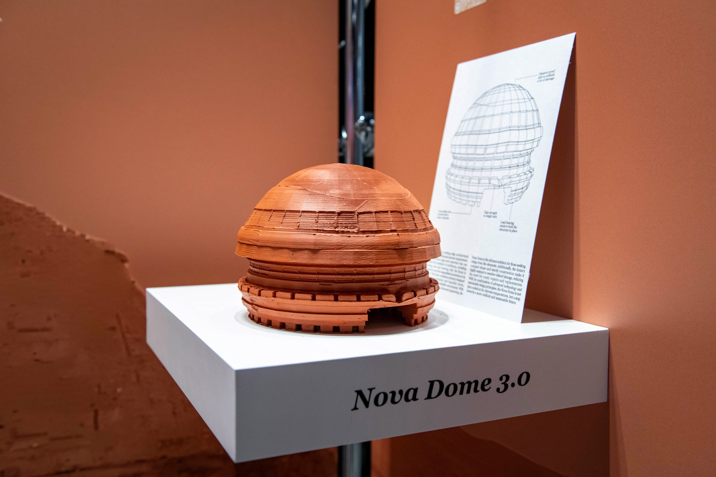 A wooden model of a dome-like building on a white shelf by a Virginia Commonwealth University student