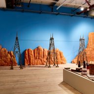 Miniature film set telephone poles with a desert backdrop