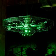 A UFO model lit up in green lights