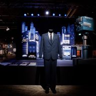 A blue suit displayed in front of a miniature city film set