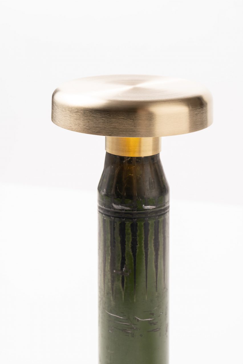 Detail of cap on top of green lamp made from shell casings