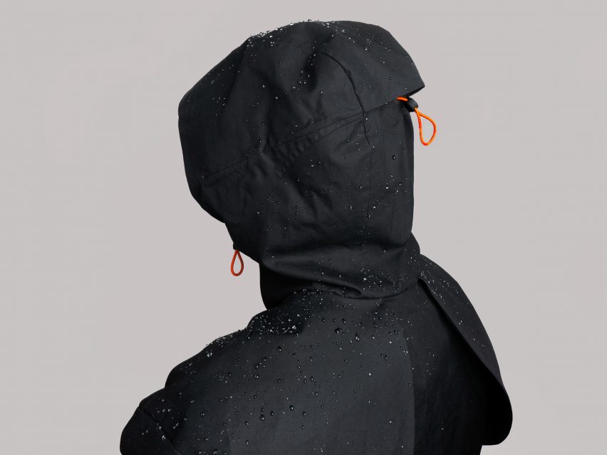 Hooded figure wearing waterproof garment