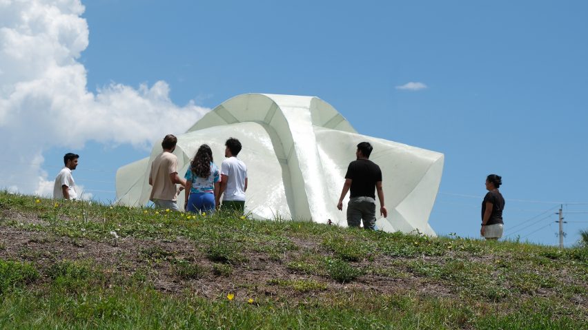 People standing around a shimmery white structure