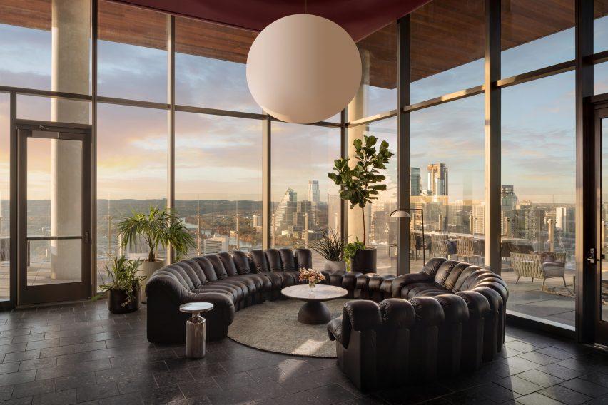 Lounge with dark furniture and a view of the Austin skyline