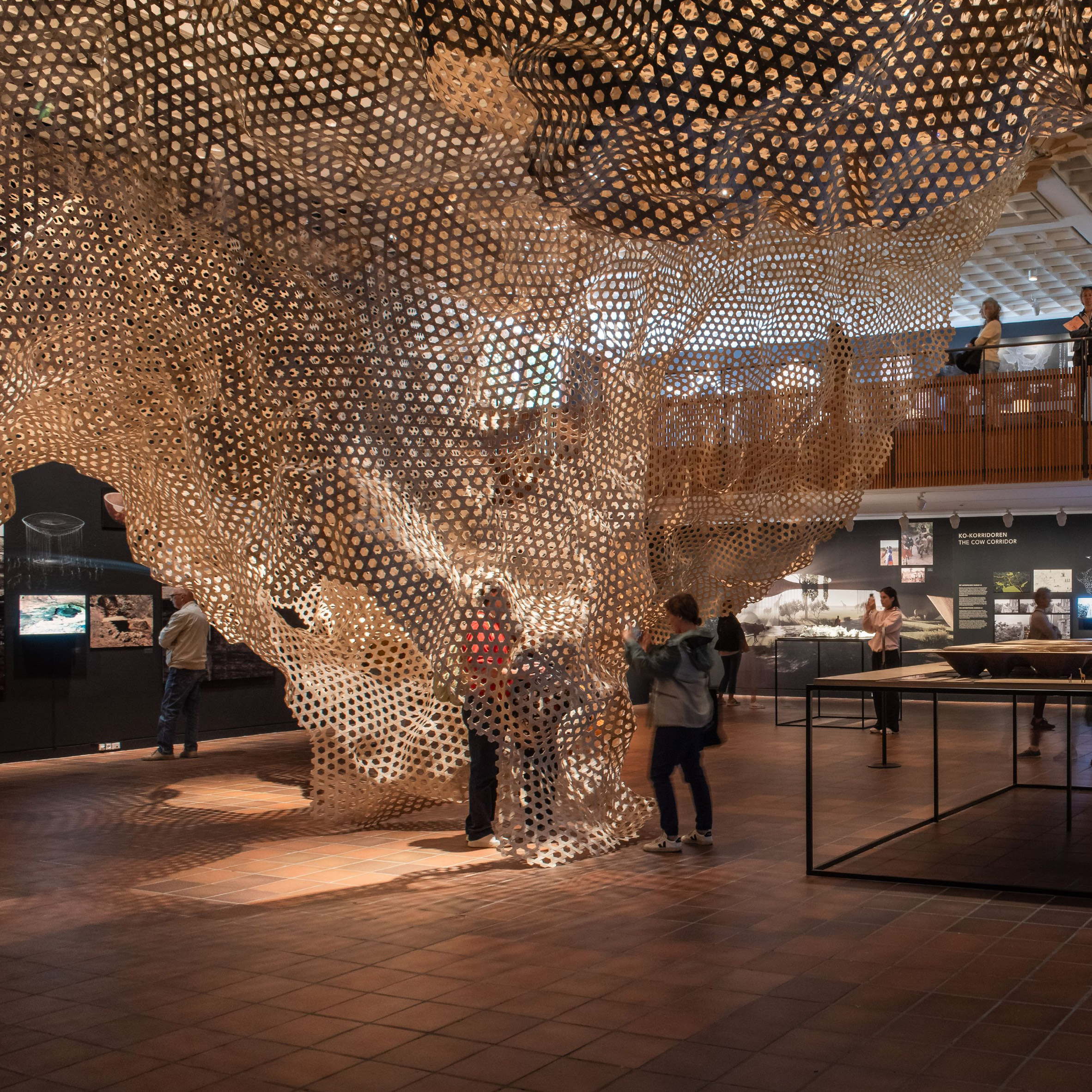 Image of visitors interacting with the mesh installation of the cave