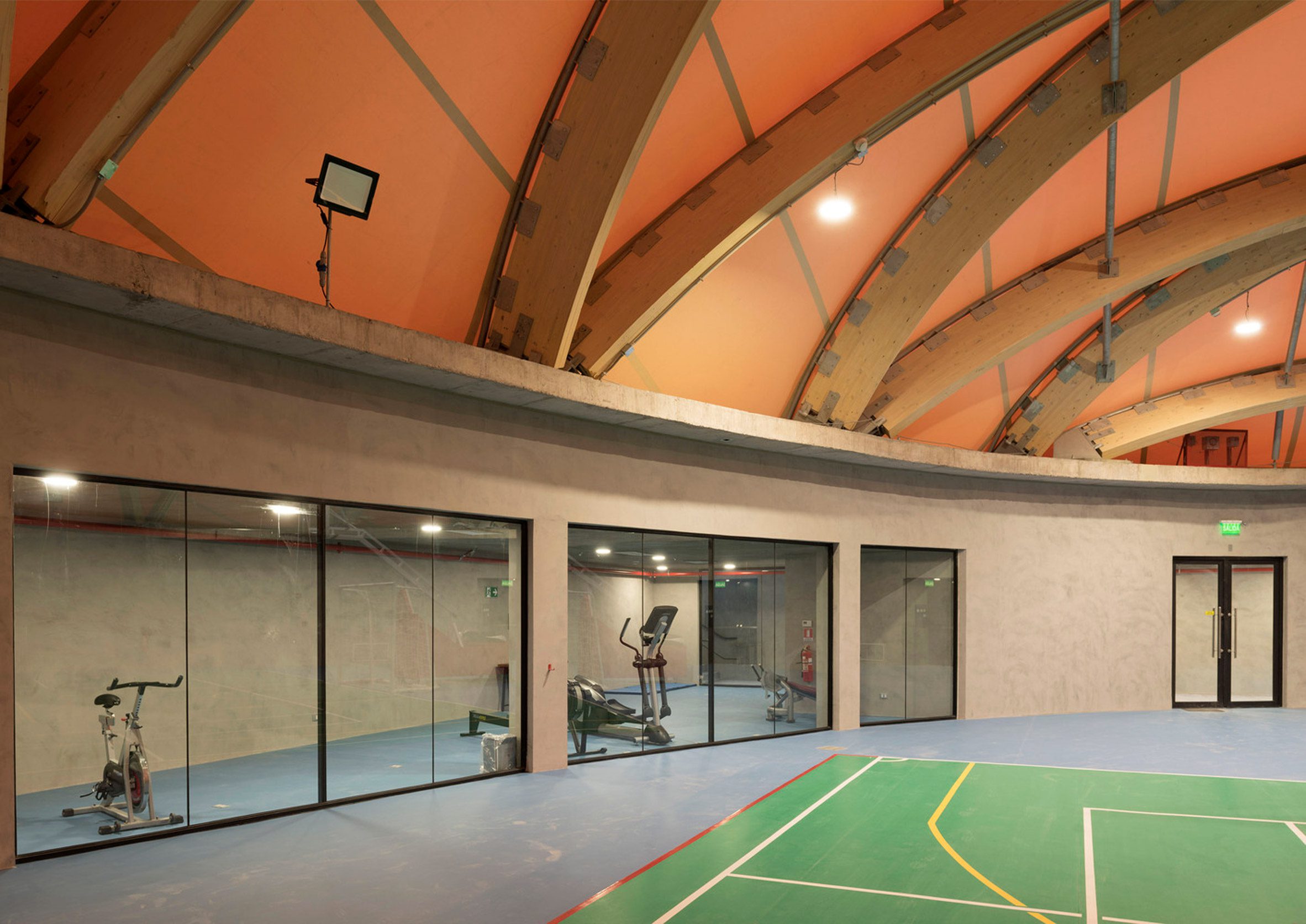 A small gym located around the sides of a basketball court