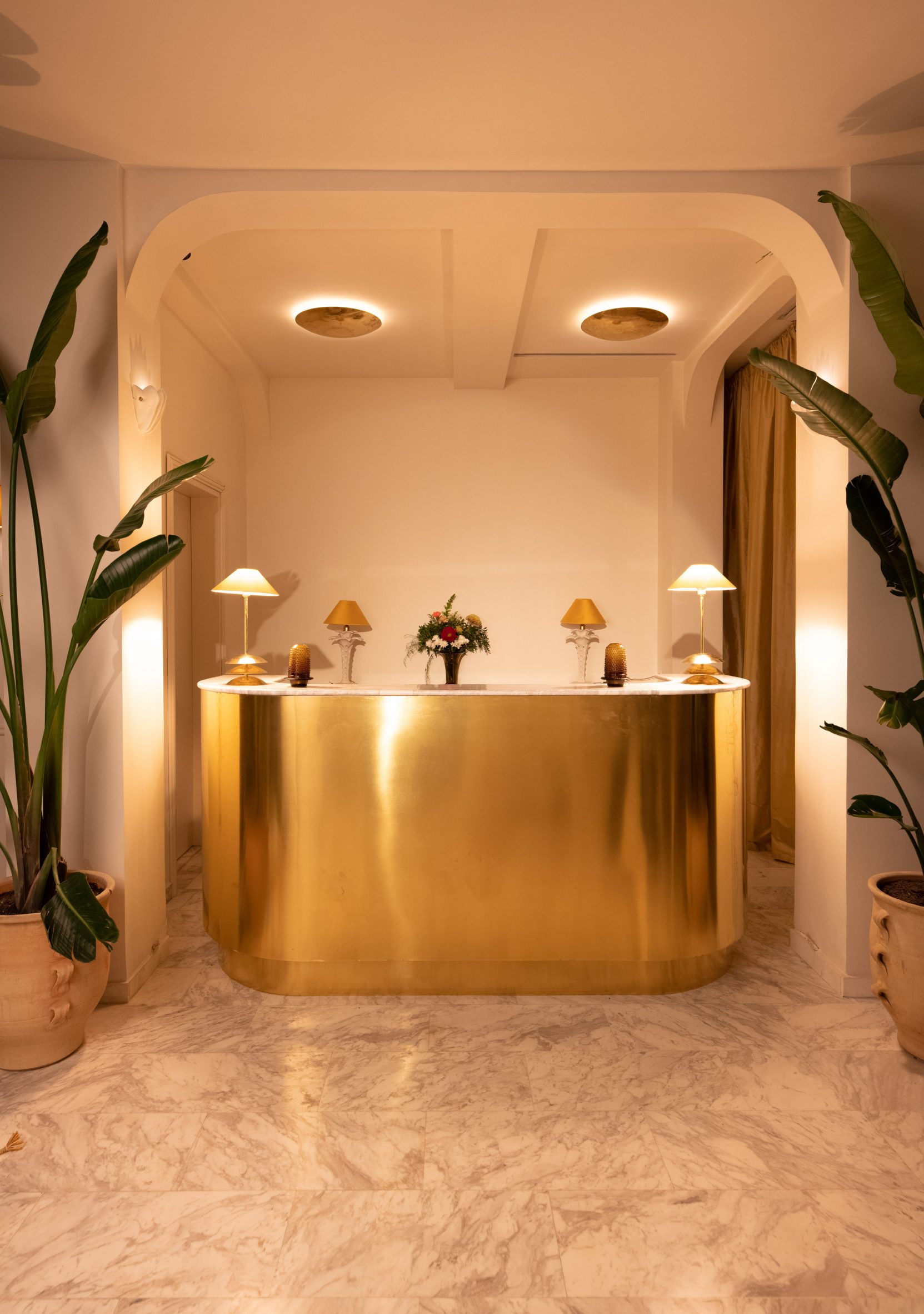 Curved brass hotel reception desk