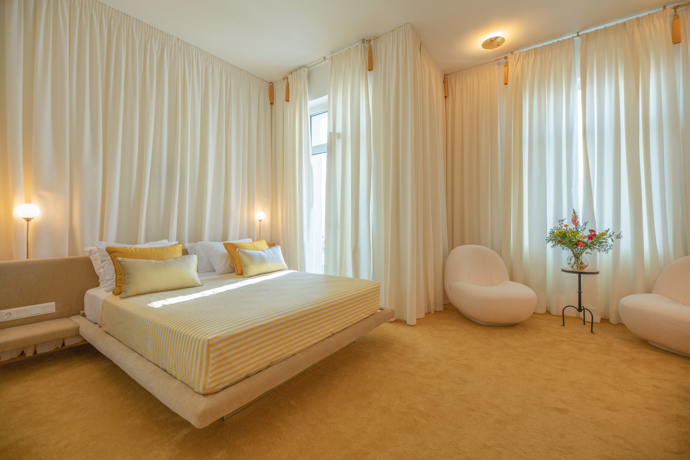 Guest room of Apollo Palm hotel with floor-to-ceiling curtains