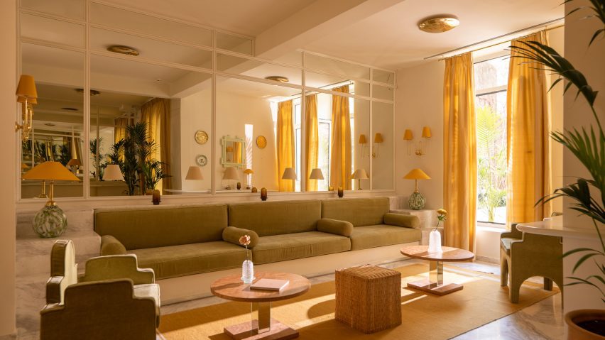 Lounge area with mirrored walls and yellow curtains