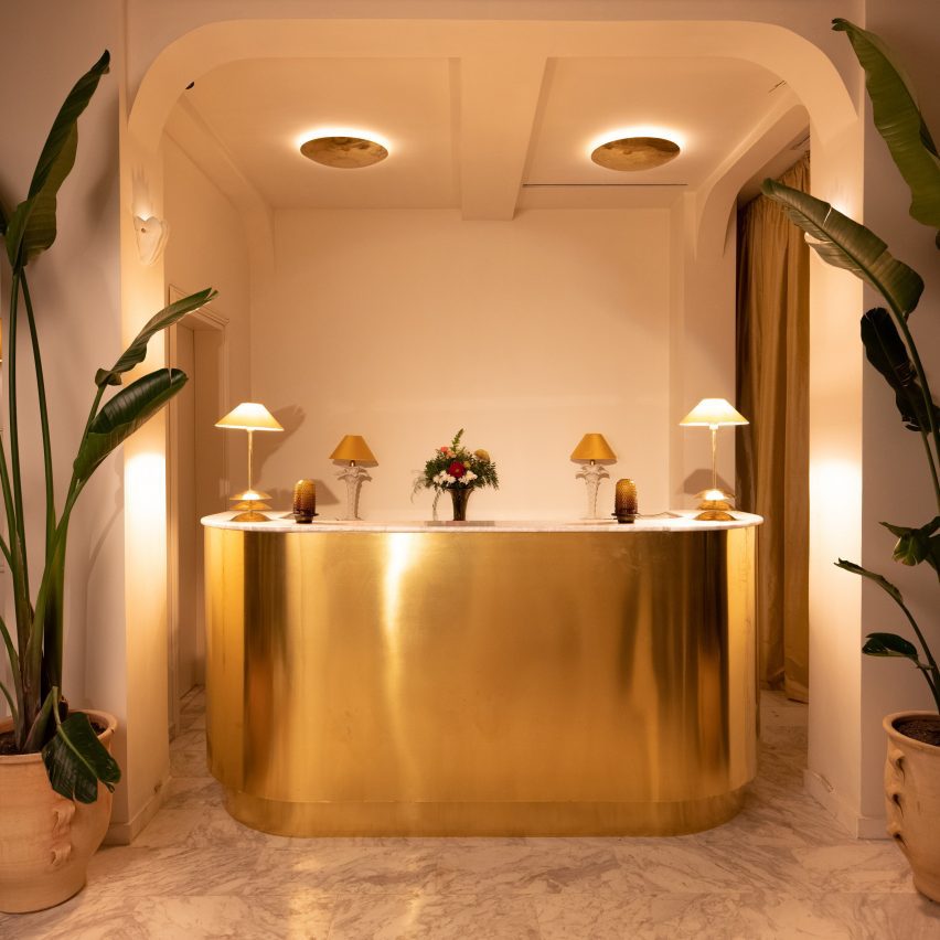 Curved brass hotel reception desk
