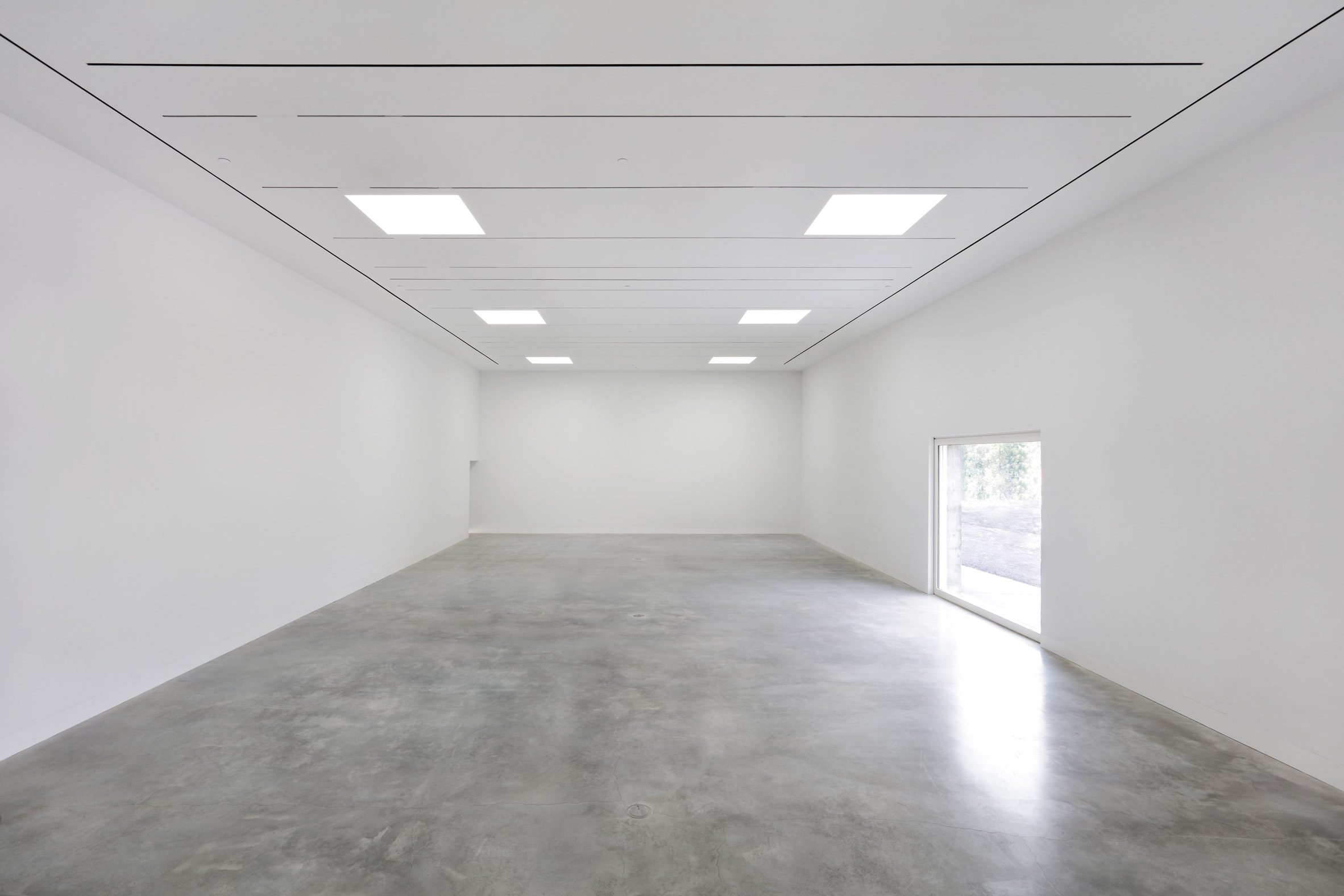 Polished concrete floors and white ceilings