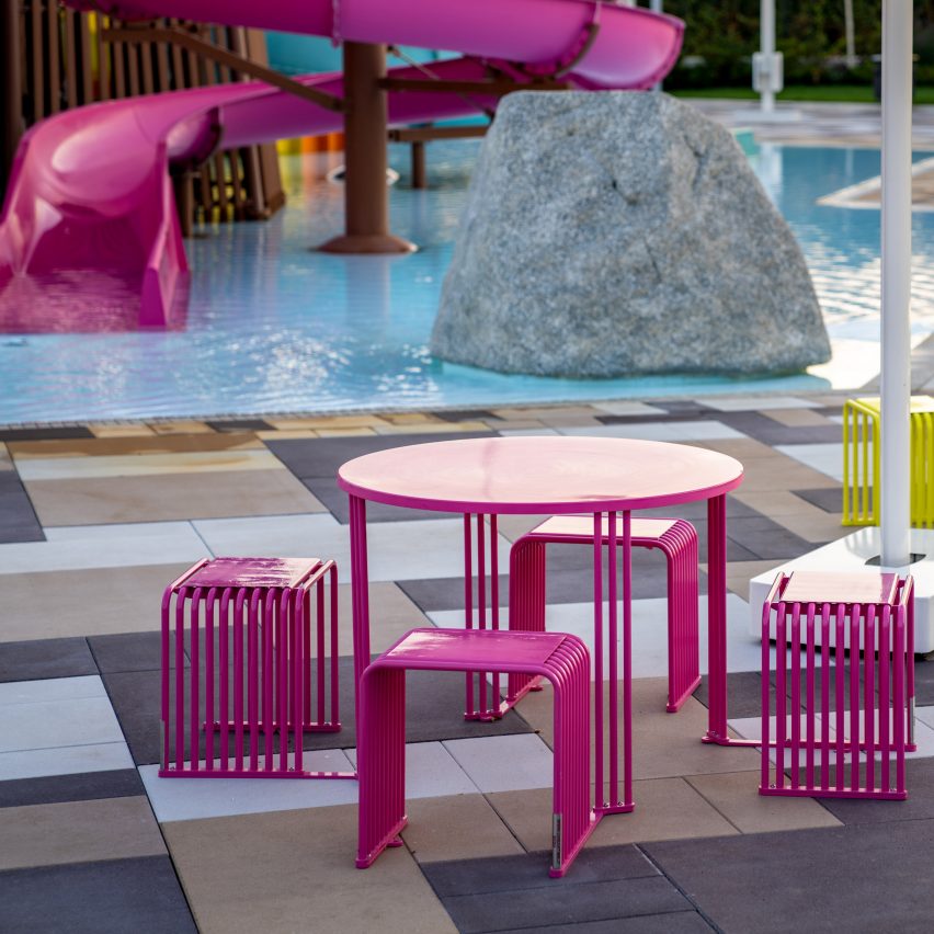 Hot pink dining set by pool with slides