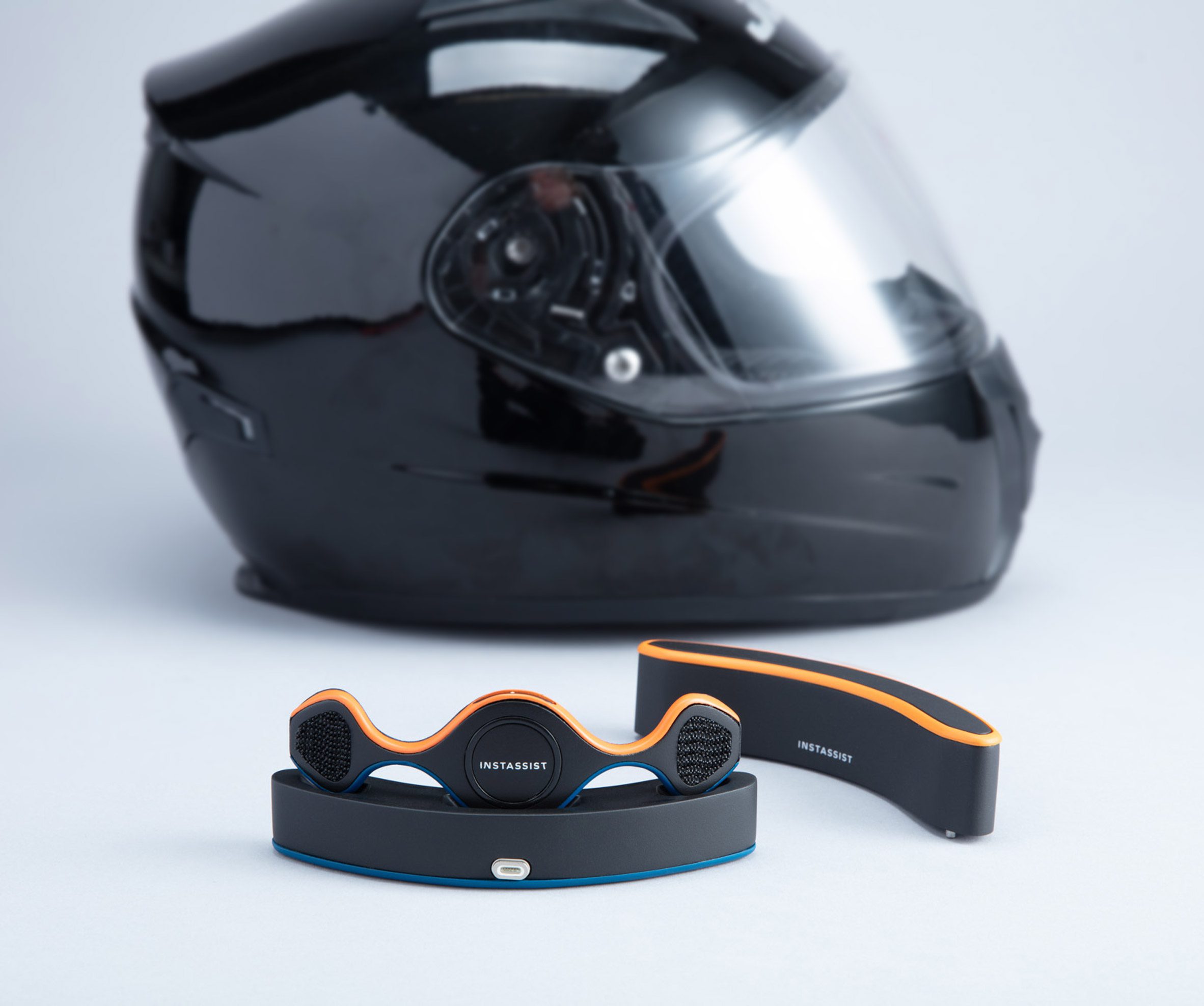 Motor accident detection device with motorcycle helmet displayed behind