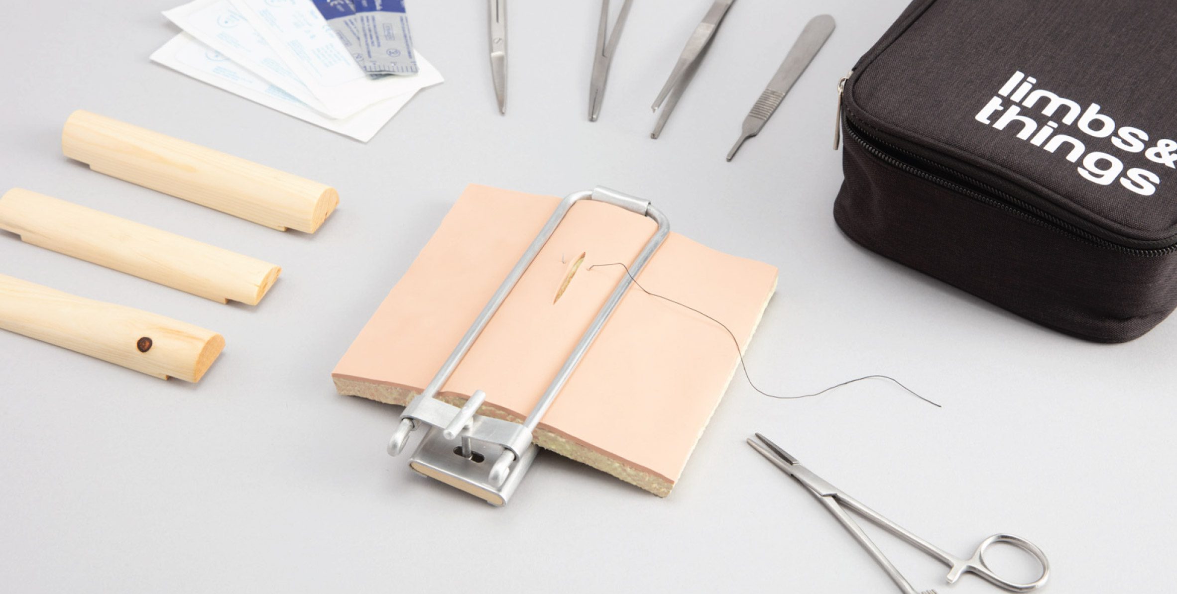 Recycled silicone suture pad surrounded by surgical tools