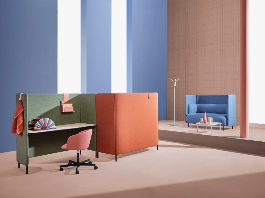 Pastel-coloured desks in lofty workplace