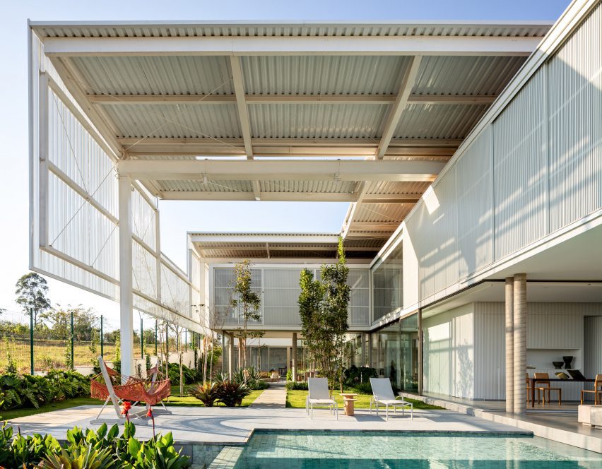 House with pool and white metal trellis