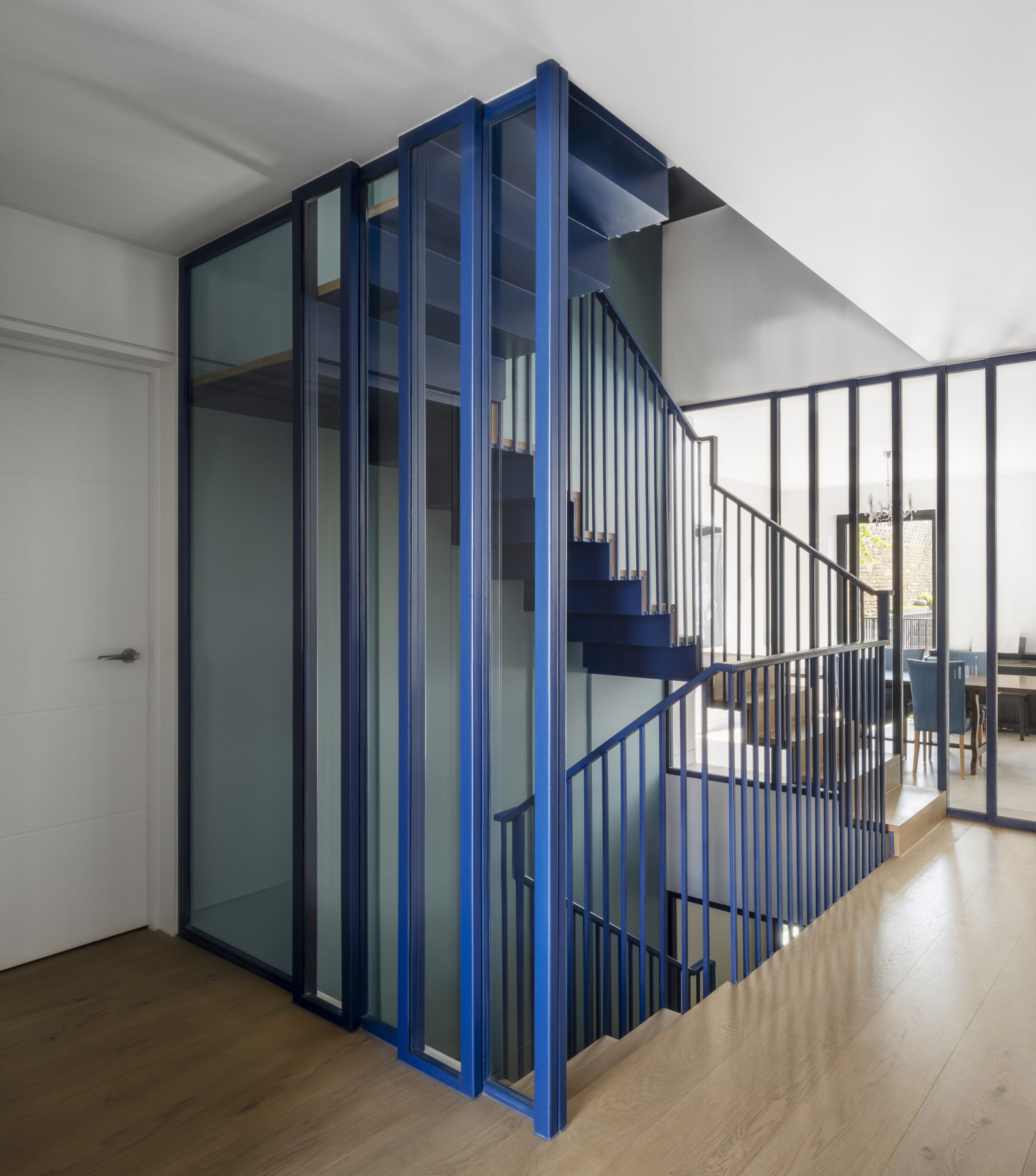 Staircase with blue balustrades by Bureau de Change