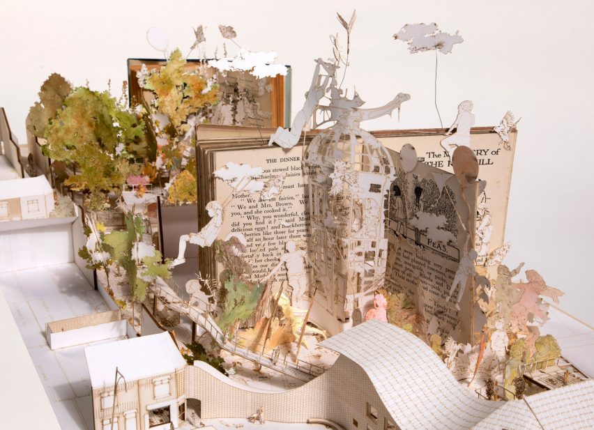 Physical model of a children's playground and parent social facility made with books and laser cut board