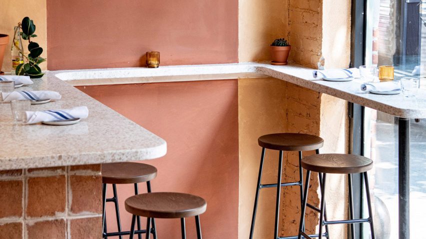 Bar area with earth-toned plaster walls at Donna restaurant
