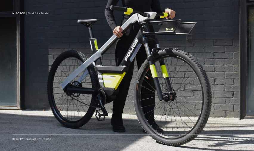 A person standing beside an electric police bike