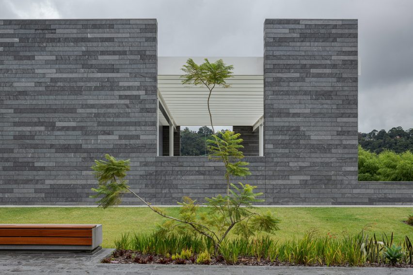 Grey rectilinear facade next to green space