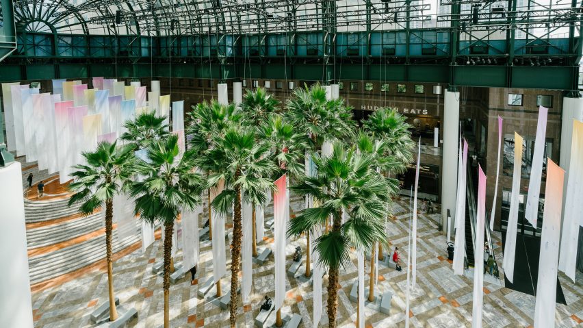 suspended banners in atrium with palm trees