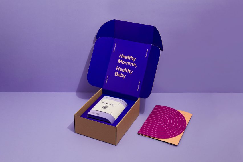 Photo of a cardboard box opened at the top to reveal the lavender-coloured Momma's Kit tin. Text printed on the cobalt blue interior of the box reads 'healthy momma, healthy baby'