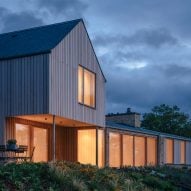 Weathered stone and larch clad Cotswolds House by Oliver Leech Architects