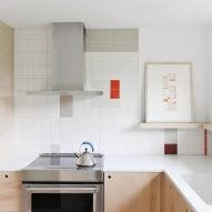 Kitchen with geometric colourful wall tiles and wood kitchen units