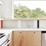 Kitchen with geometric colourful wall tiles and wood kitchen units