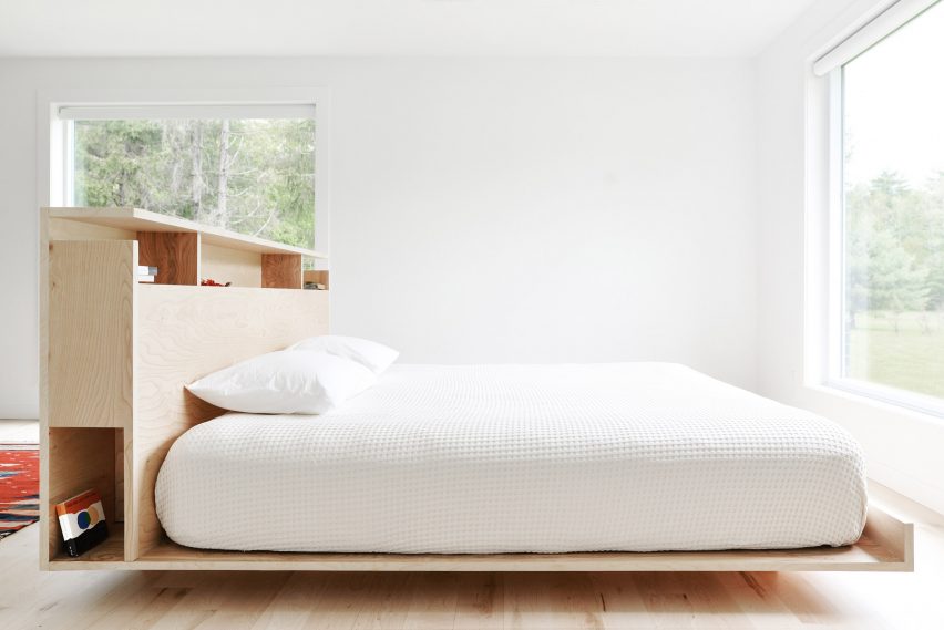 Freestanding wood-framed bed with built-in storage