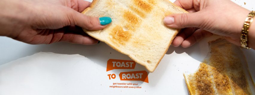 Two hands holding opposite sides of a piece of toast with project logo below in red
