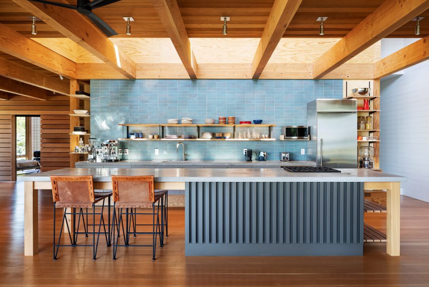 Glazed-brick blue backsplash in wood-lined kitchen